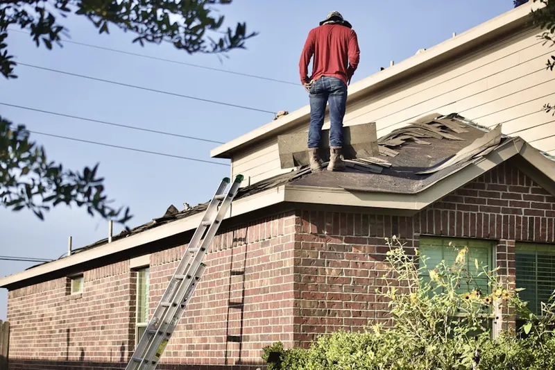 Professional roofer working on a residential roof in Grand Sprute